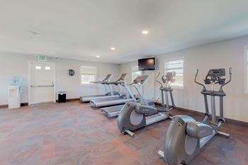 A gym with treadmills and exercise bikes.